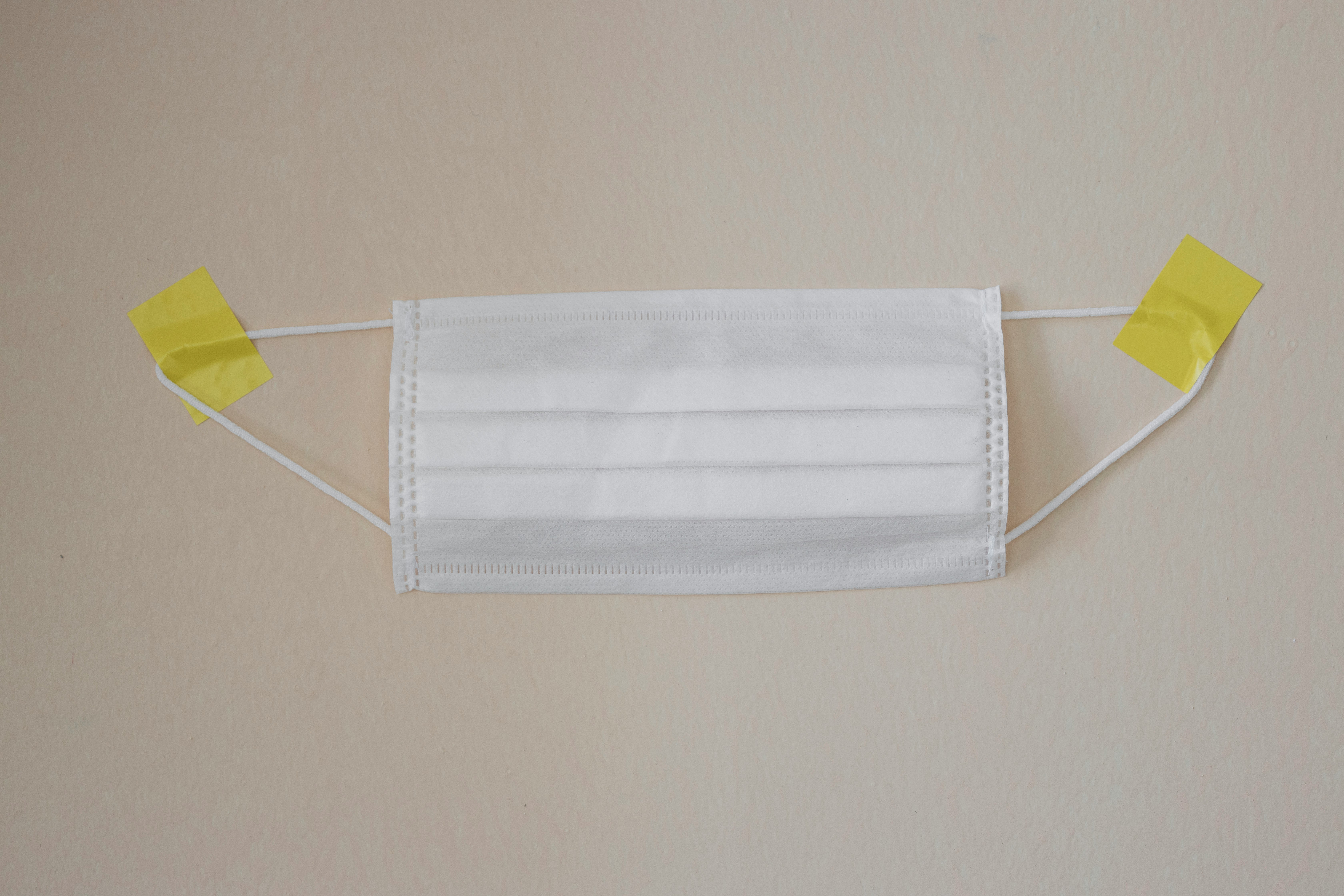 white towel on yellow clothes hanger
